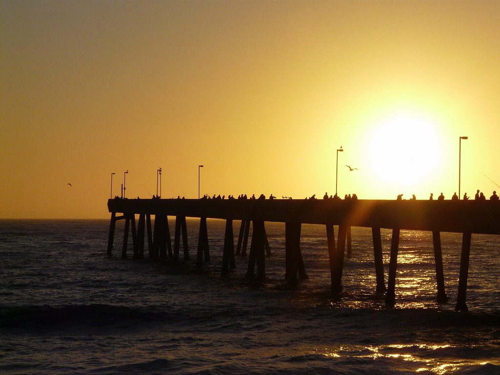 The pier at Pacifica silhouetted against the sun setting over the Pacific
